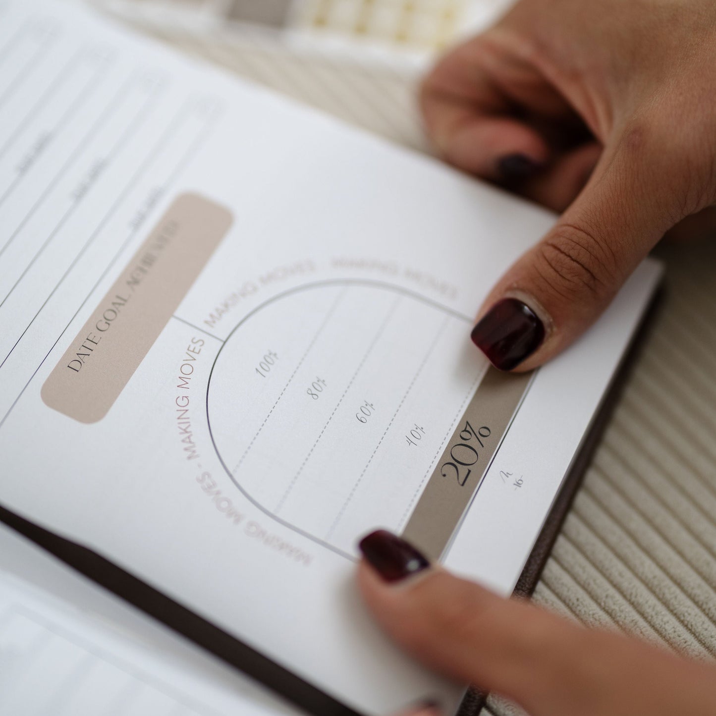 Person holding a book with a diagram on a textured surface